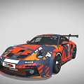 Porsche Race Car With Orange And Blue Camouflage Design And Rear Spoiler