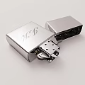 Silver Metal Lighter With Decorative Engraved Pattern In Open State Showing Internal Structure