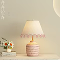 Table Lamp With Beige Fabric Shade Pink Tassels And Ceramic Striped Base On Wooden Table