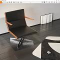 Black Leisure Chair with Wooden Armrests and Metal Legs on Dark Floor with Open Book