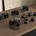 Various Digital Cameras And Multiple Lenses Arranged On Wooden Table With Decorative Painting