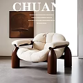 Elegant Modern Leisure Chair With Beige Padded Seat And Dark Wooden Legs In Minimalist Interior