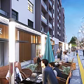 Lively Commercial Street With Multi Story Buildings Outdoor Seating Decorative Lights And Pedestrians