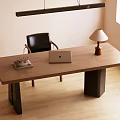 Modern Wooden Desk With Laptop Table Lamp Books And Black Chair In Natural Light