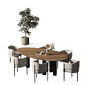 Round Modern Dining Table Set with Grey Chairs Green Potted Plant and Books on Table
