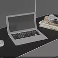 Silver Laptop with White Mouse and Headphones on Black Desk with Books