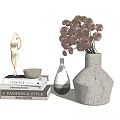 White Speckled Decorative Vase With Dried Flowers And Golden Sculpture On Stacked Books Home Decor