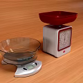 Commercial Kitchen Weighing Scales With Mechanical Red Bowl And Digital Glass Bowl On Wooden Tabletop