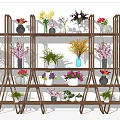 Beautiful Flower Arrangements In Various Decorative Vases On Multi Layer Display Shelves