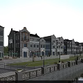 Traditional Gray Brick Commercial Street With Riverside View And Outdoor Seating Areas