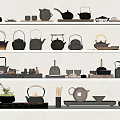 Black Tea Ware Collection with Various Teapots Cups and Wooden Handles on White Shelves