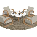Round Dining Table with Four White Chairs Wooden Armrests and Decorative Items on Woven Rug