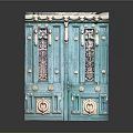 Turquoise Double Entrance Door With Ornate Wrought Iron Windows And Decorative Top And Round Door Knockers