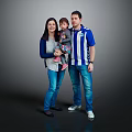 Happy Family Portrait With Parents And Child Standing Together In Casual Clothing