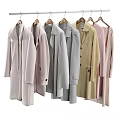 Multiple Soft Colored Long Coats Hanging On Wooden Hangers With Casual Style And Long Sleeves