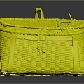 Cute Rabbit Resting in Handwoven Yellow Basket with Leather Straps on Gray Surface