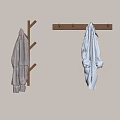 Wooden Tree Shaped And Long Bar Hangers With Checkered And Striped Garments On Light Wall