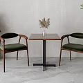 Minimalist Wooden Table And Chair Set With Green Upholstered Seats Black Metal Base And Plants