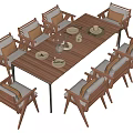 Wooden Outdoor Table with Cushioned Chairs Plates and Wine Glasses on Patio