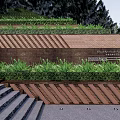 Layered Retaining Wall With Green Grass Cover And Brick Design Near Stone Stairs And Trees