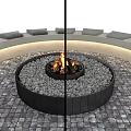 Outdoor Circular Fire Pit With Black Frame And Gray Pebbles For Garden Decor