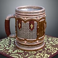 Decorative Metal And Wooden Mug With Shield Motifs Brown Handle On Intricate Patterned Mat