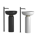 Two Black and White Pedestal Washbasins with Black Faucets and Gold Base Accents
