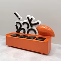 Orange Vase With White And Black Letter Decorations And Round Floral Design