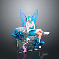 Blue Haired Fairy Figurine Sitting On Decorative Box With Blue Wings And Feathers