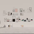 Assorted Framed Wall Art Display On White Wall With People Silhouettes