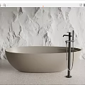Modern Freestanding Neutral Beige Bathtub With Black Faucet And White Textured Stone Wall