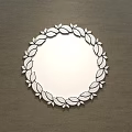 Round Decorative Mirror with White Leaf Frame Reflecting Bedroom Interior Wooden Floor Copper Lamp
