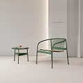 Green Metal Frame Lounge Chair With Woven Seat And Side Table In Minimalist Interior