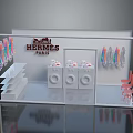Hermes Paris Display Case With Colored Items White Shelves And Chairs