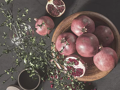 Fresh Pomegranates in Wooden Bowl with Sliced Fruit and Red Seeds on Dark Table 3d model