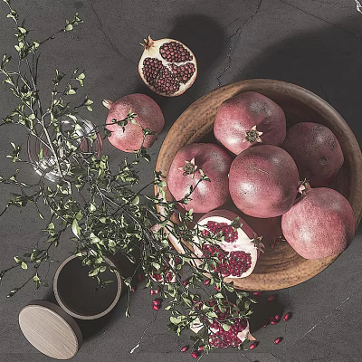 Fresh Pomegranates in Wooden Bowl with Sliced Fruit and Red Seeds on Dark Table 3d model