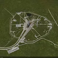 Futuristic Circular Complex Aerial View With Central Tower And Radial Roads On Green Grassland