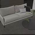 Modern Two-Seater Sofa With Beige Upholstery Pillows Round Coffee Table And Plant Interior