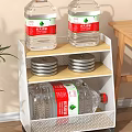 White Multi Tiered Storage Rack With Nongfu Spring Water Bottles And Metal Caps