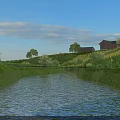 Scenic River Landscape With Green Grass Trees Small Houses And Clouds Under Blue Sky