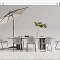 Modern Outdoor Table Setup With Woven Chairs Umbrella Vase And Green Plant
