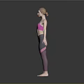 Woman in pink sports bra and grey leggings standing with arms outstretched against grey background