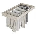 Light Colored Clothes on White Wall Mounted Hanger with Long Sleeve Tops and Pants