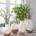 White Vases With Terracotta Base Holding Green Leaves And Orange Berries Near Bright Window