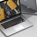 Open Silver Apple Laptop Displaying Ice Pop Image On Screen With Closed Laptop 3d model