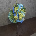 Blue Green Floral Arrangement With Fan Shaped Decor On Tripod Stand Grey Wall Wooden Floor