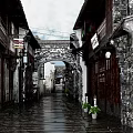 Ancient Architecture Street Scene With Stone Archway Wooden Buildings And Traditional Lanterns