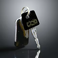 Shiny Metal Key With Black Tag And Chain On Dark Surface