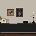 Dark TV Stand with Table Lamp Photo Frames Open Book Vase Flowers and Wall Decor