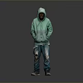 Man in Green Hoodie and Ripped Jeans Standing Against Gray Background with Sneakers
